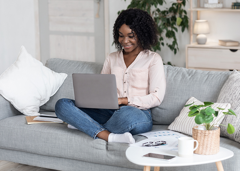 A woman balancing a full-time remote work and side hustle
